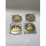 A collection of large gold plated commemorative me