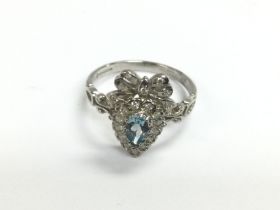 A 9ct white gold bow style ring set with a pear sh