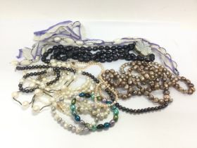 A collection of pearl necklaces some with silver c