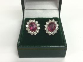 A par of 18ct white gold oval ruby and diamond clu