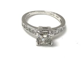 A platinum ring set with central square cut diamon