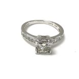 A platinum ring set with central square cut diamon