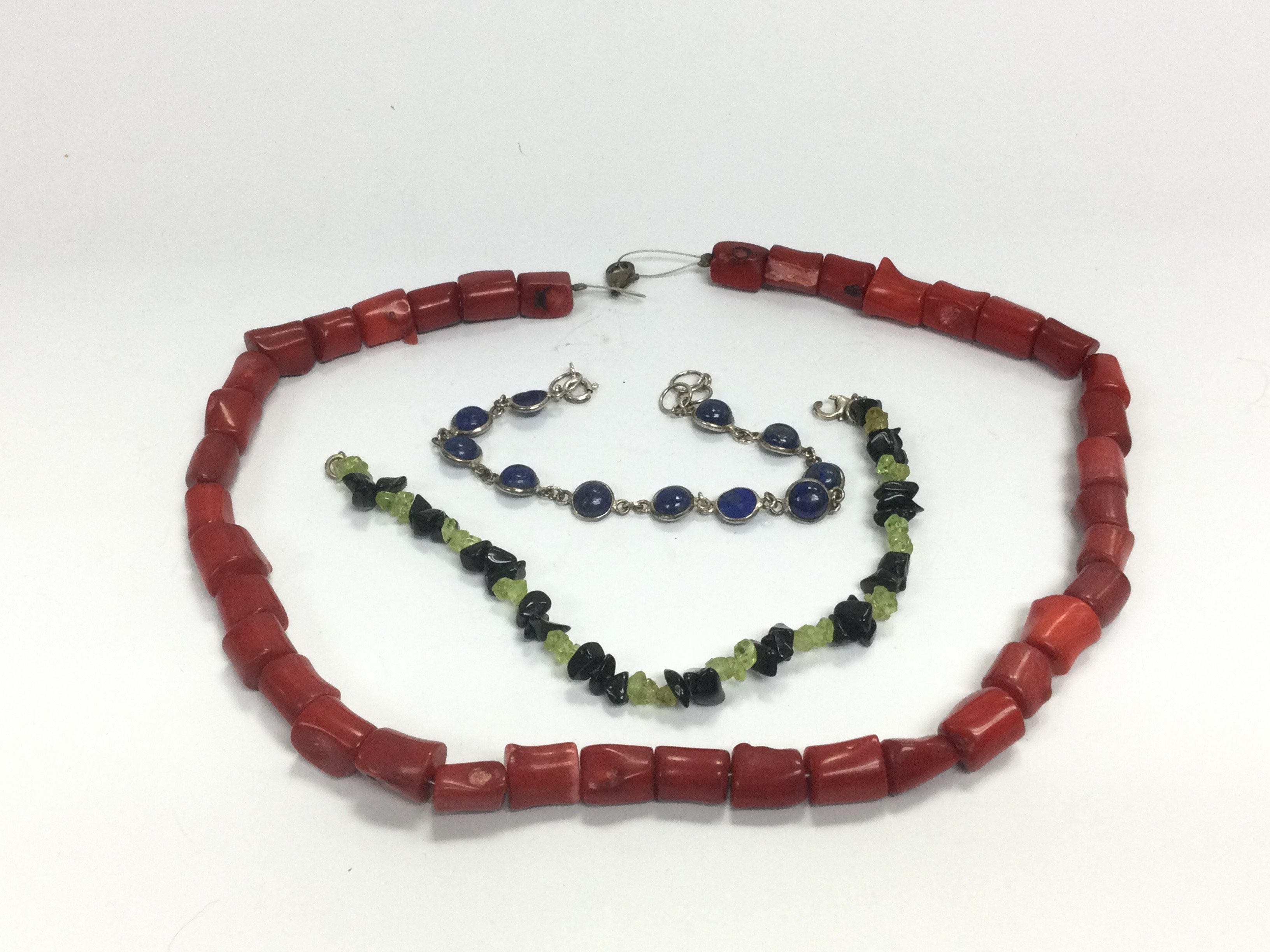 A coral necklace, lapis lazuli bracelet and one ot