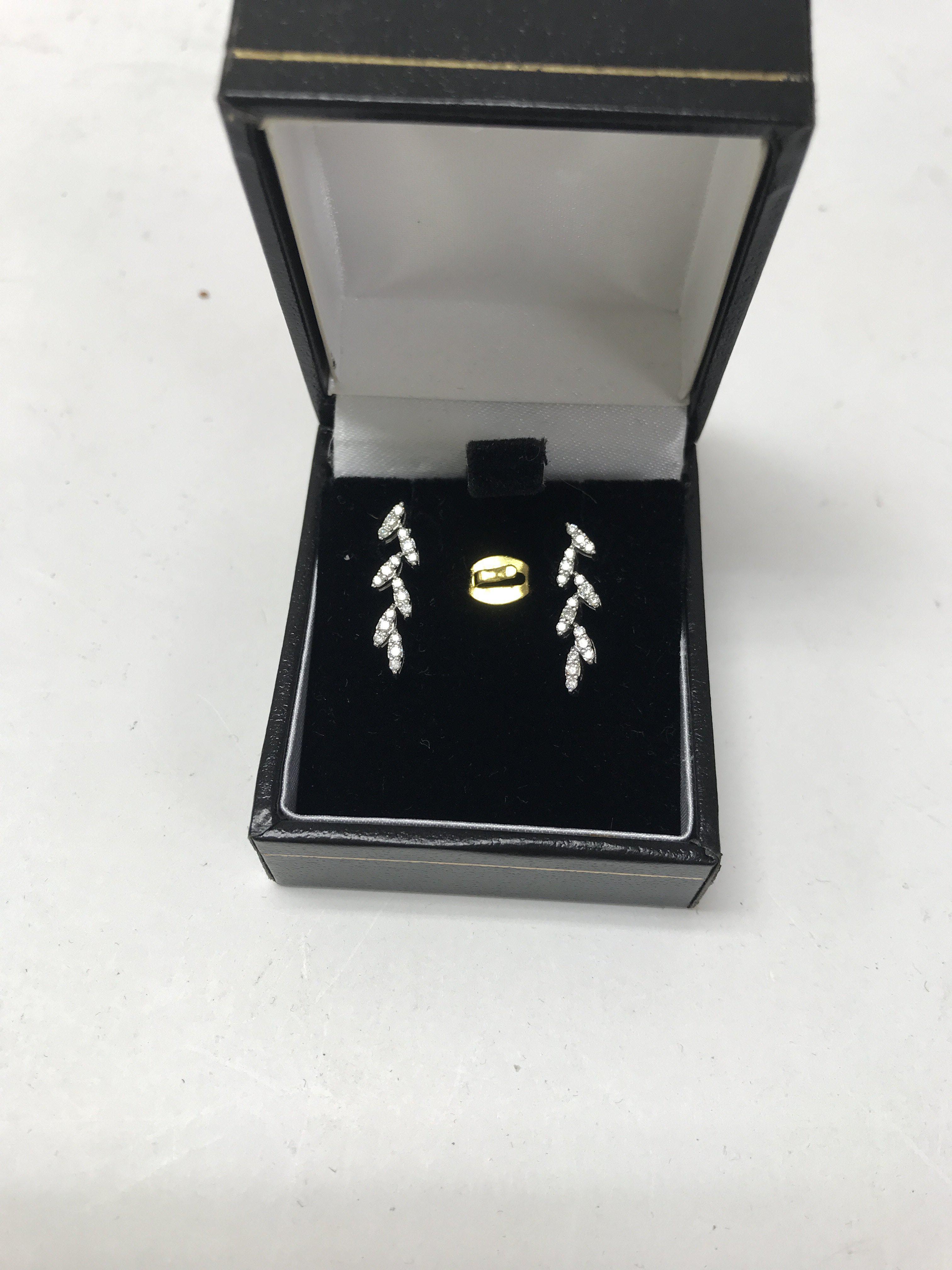 A 14ct white gold diamond leaf earrings. Approx 1.