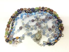 A bag of glass bead necklaces including a millefio