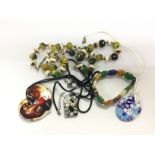 A collection of glass necklaces including Murano e