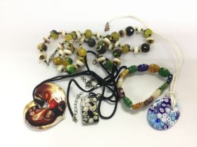 A collection of glass necklaces including Murano e