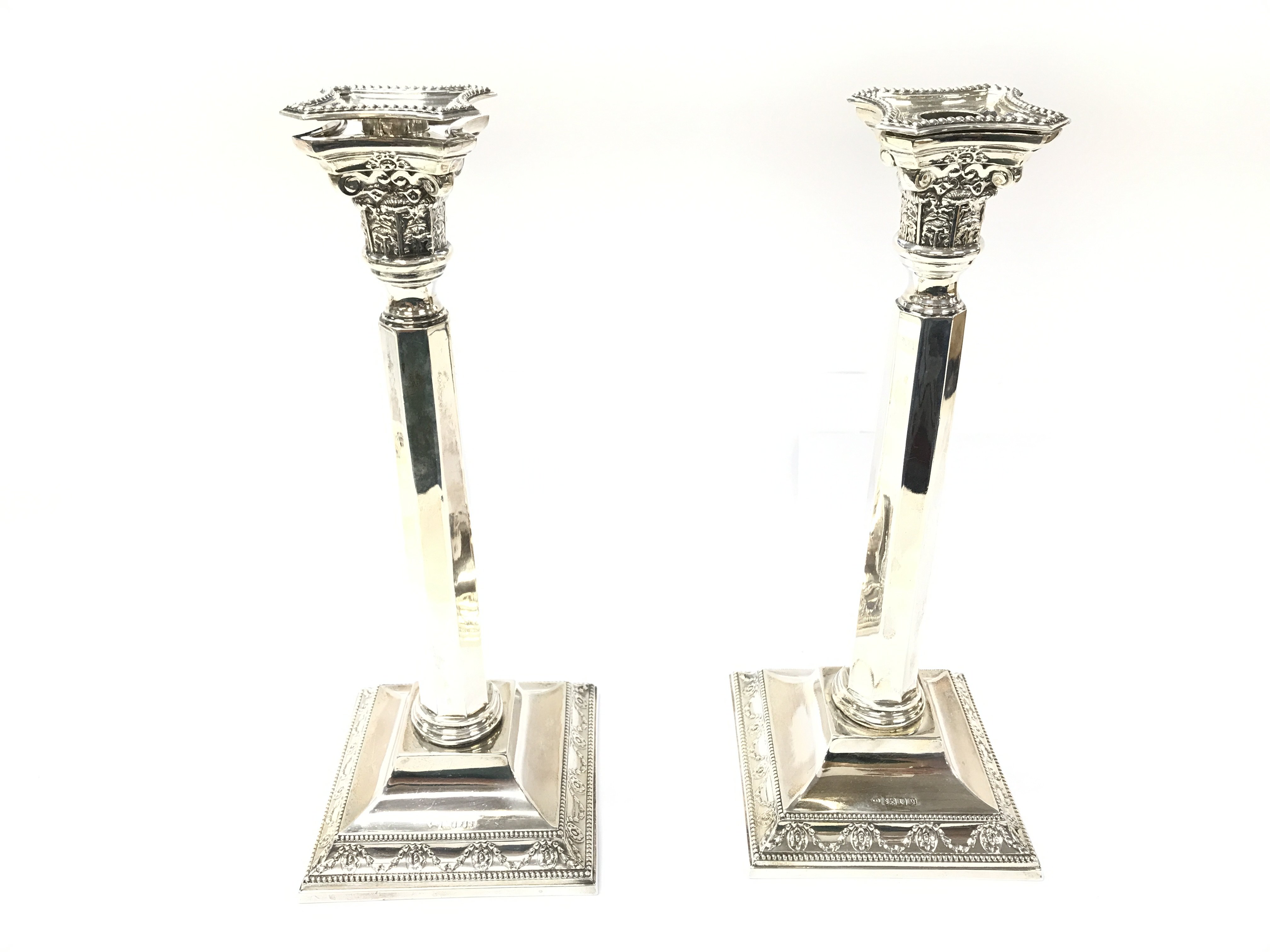 A pair of large candlesticks with London hallmarks