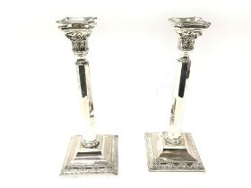 A pair of large candlesticks with London hallmarks