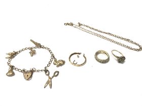 A 9ct gold charm bracelet with charms. Also two 9ct gold rings and other 9ct items. Total weight