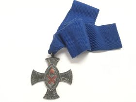 Sterling silver medallion in a decorative cross sh