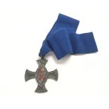 Sterling silver medallion in a decorative cross sh