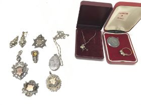 A collection of predominantly silver items includi