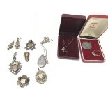 A collection of predominantly silver items includi