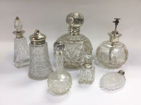 Six cut glass perfume bottles with silver bands or