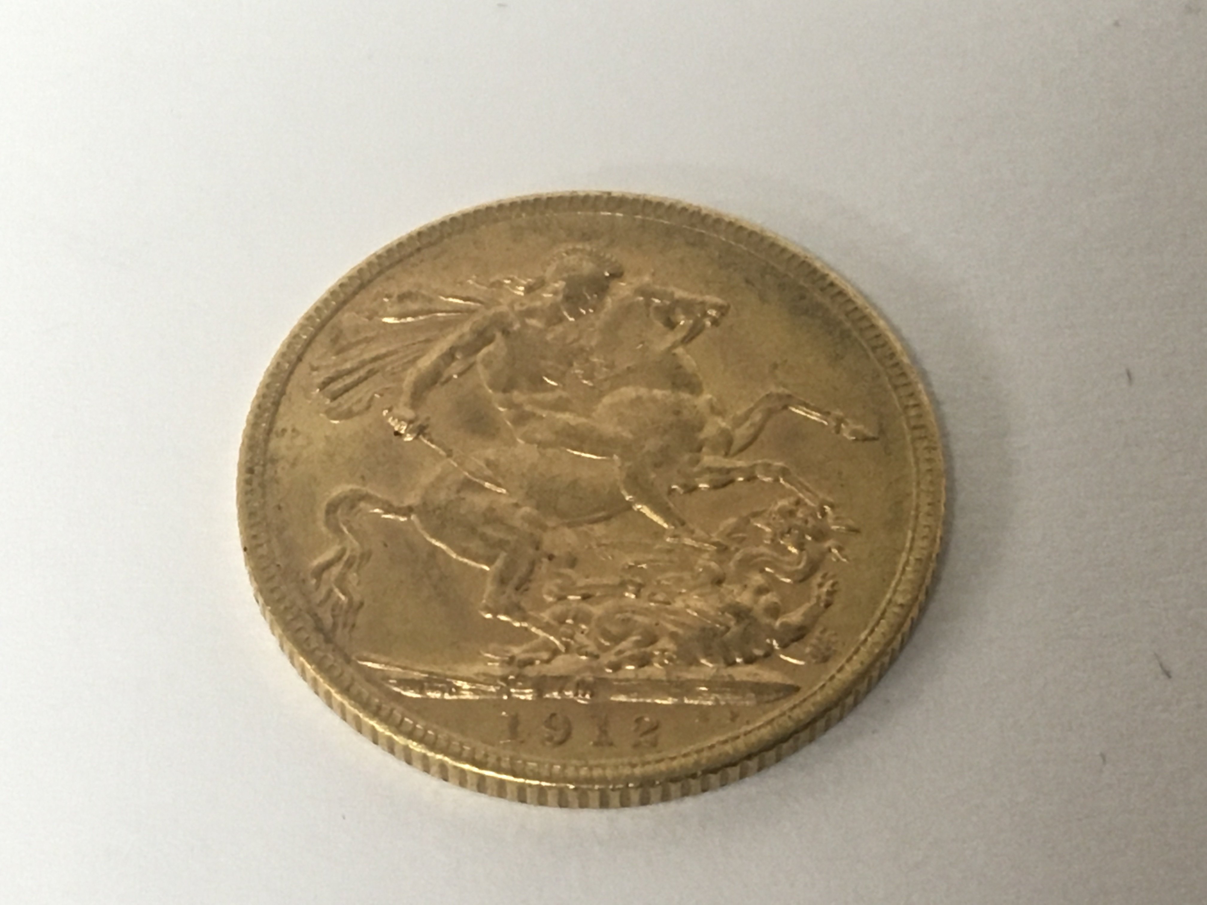 A Gold 1912 George V gold sovereign.