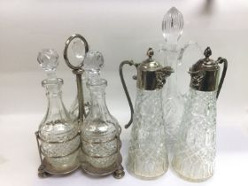 A Mappin & Webb triple decanter stand and three gl