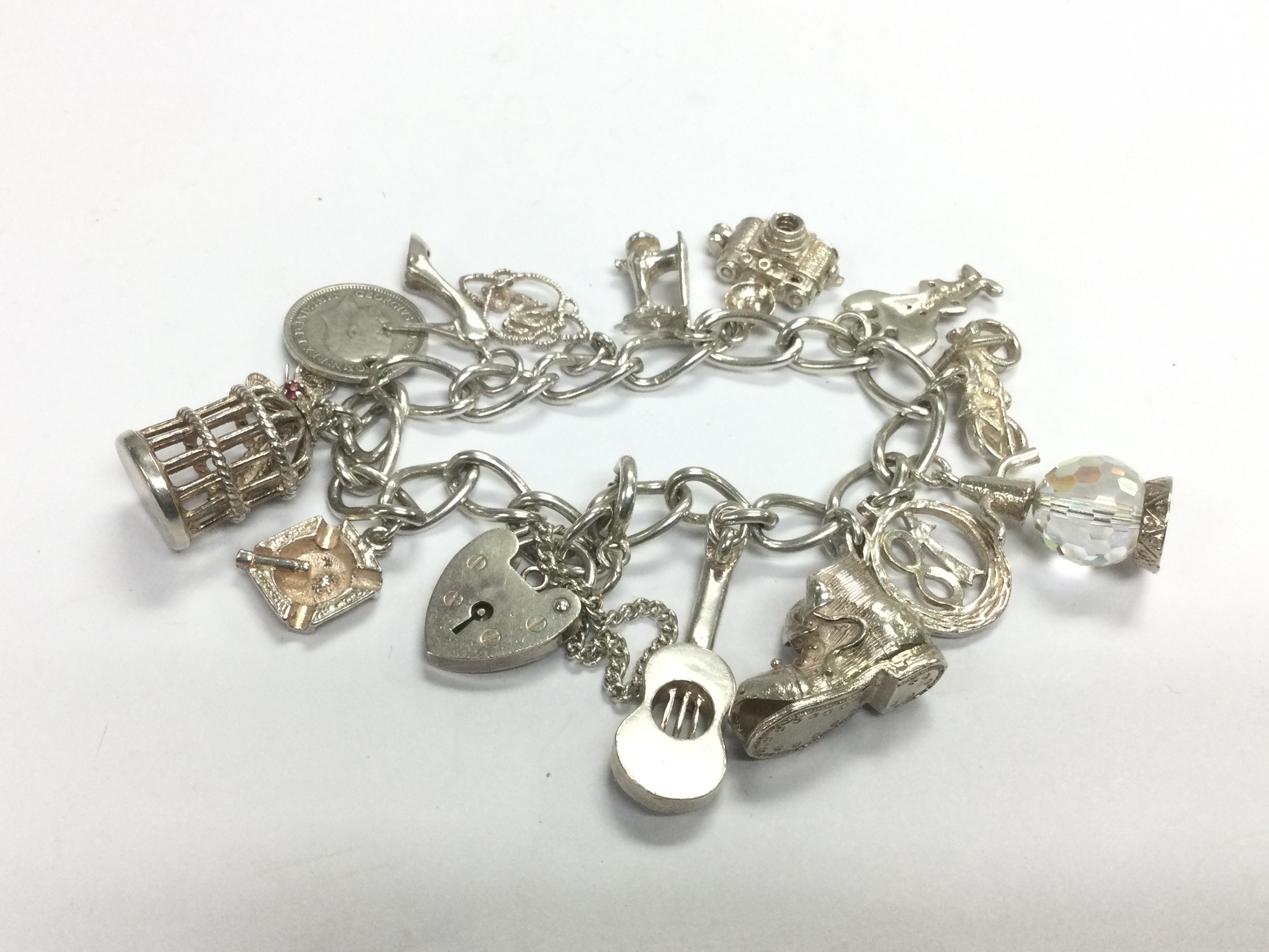 A silver charm bracelet. Shipping category A. NO R