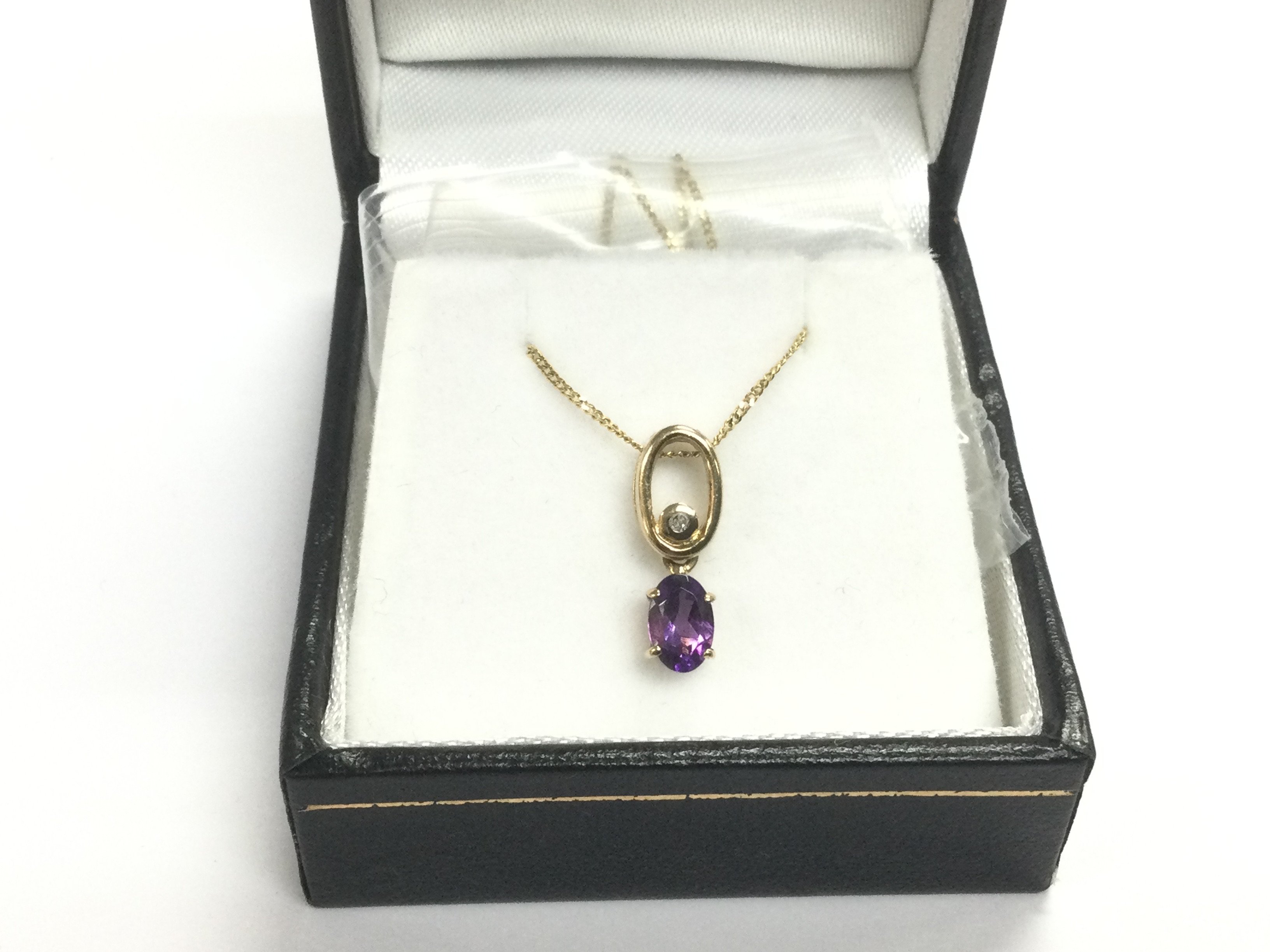 A 9ct gold, oval amethyst and round cut diamond pe