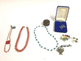 A collection of coral type necklaces and other odd