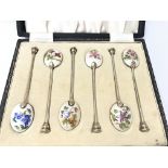 A cased set of silver and enamel coffee spoons. Bi