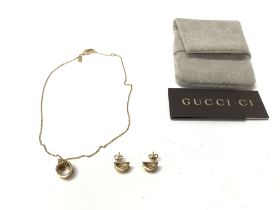 An 18ct gold a Gucci pendant and matching earring