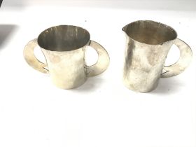 Unmarked silver jug and double handled mug with ha