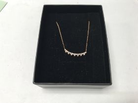 A 14ct rose gold diamond set necklace. Approx 15pt