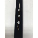 A 14ct rose gold evil eye diamond set bracelet. Ap