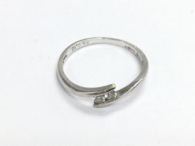 WITHDRAWN -A 9ct white gold ring set with two diamonds, appro