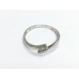 WITHDRAWN -A 9ct white gold ring set with two diamonds, appro