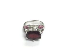 A 14k white gold ring set with rubies and diamonds