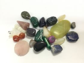 A small collection of loose gemstones. Shipping ca