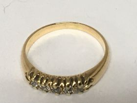 An 18carat gold ring set with a row of chip diamon