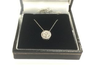 A 9ct white gold diamond cluster necklace, RBC dia