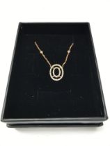 An 18ct rose gold necklace with an oval diamond se