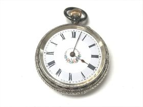 A silver pocket watch with an enamel face. Winds a