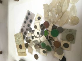 A collection of mother of pearl Chinese gaming tokens Roman coins and other coins..