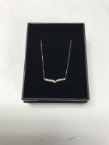 A 14ct rose gold necklace set with diamonds. Appro