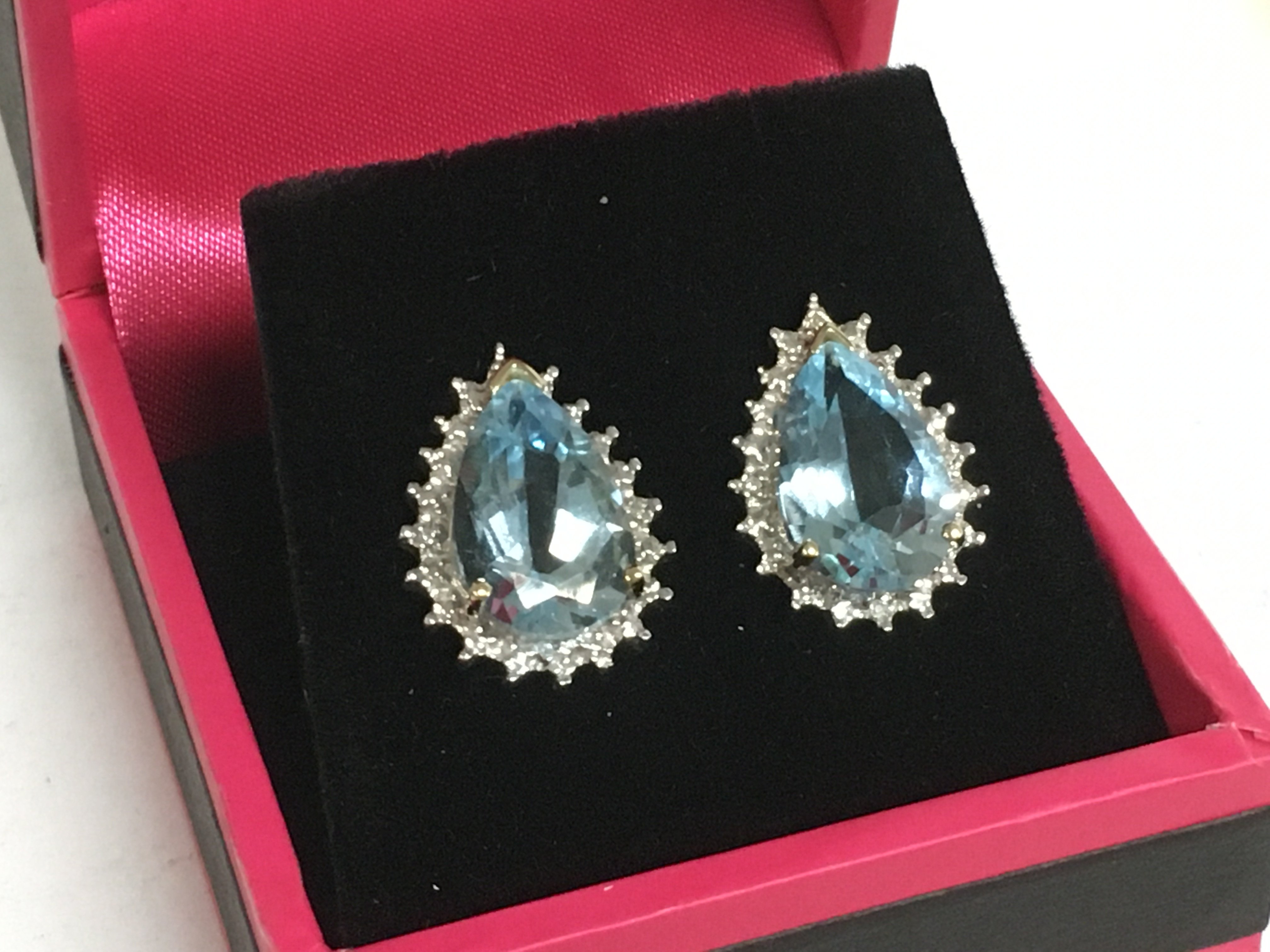 A pair of 9ct earrings set with blue topaz stones.