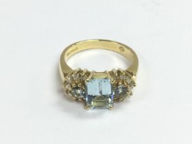 An 18ct gold ring set with an emerald cut aquamari