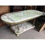 A Green Onyx gilt and brass coffee table supported by four Putto figures. Dimensions 47x107x45cm