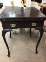 A Edwardian mahogany envelope card table with sing