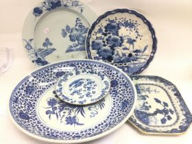 A collection of blue and white chargers, plates an