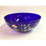 A large blue glass hand painted bowl. Has some dam