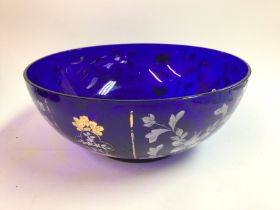 A large blue glass hand painted bowl. Has some dam