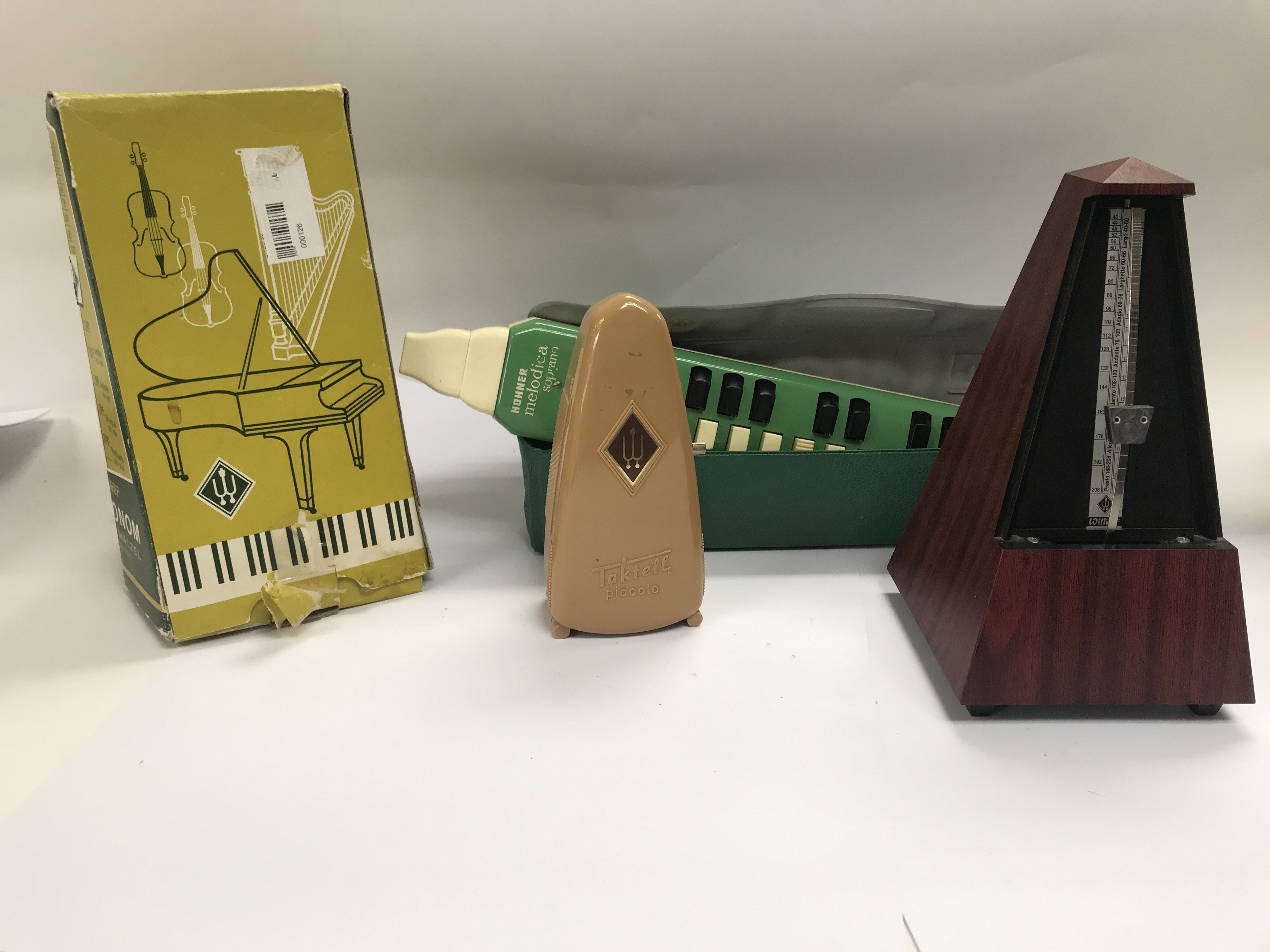 Three metronomes one harmonica and a mandolin.