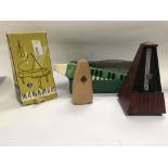 Three metronomes one harmonica and a mandolin.