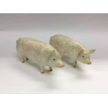 Two Beswick figures of pigs, one has a chipped ear