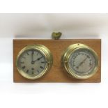 A wall mounted brass clock and barometer set. Ship